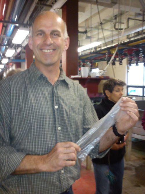 Ed Baker with a piece of plastic that’s used to soak up and measure pollutants